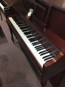 upright piano with a bench in front of it