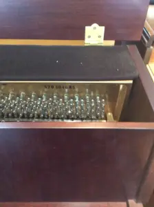 upright piano with a bench in front of it