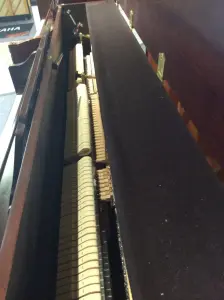 upright piano with a bench in front of it