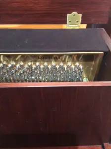 upright piano with a bench in front of it