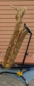 A large, curved metal instrument about three to four feet long. It has many keys and buttons along its smooth, shiny brass body. The wide, flared bell at the end.