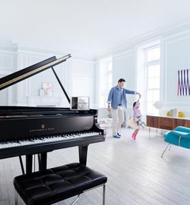 Dad and daughter dancing with Spirio grand piano