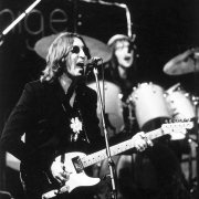 John Lennon playing guitar and singing