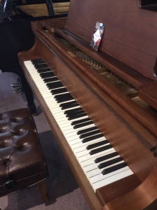 brown kawai grand piano with bench