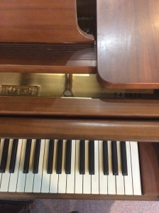 brown kawai grand piano with bench